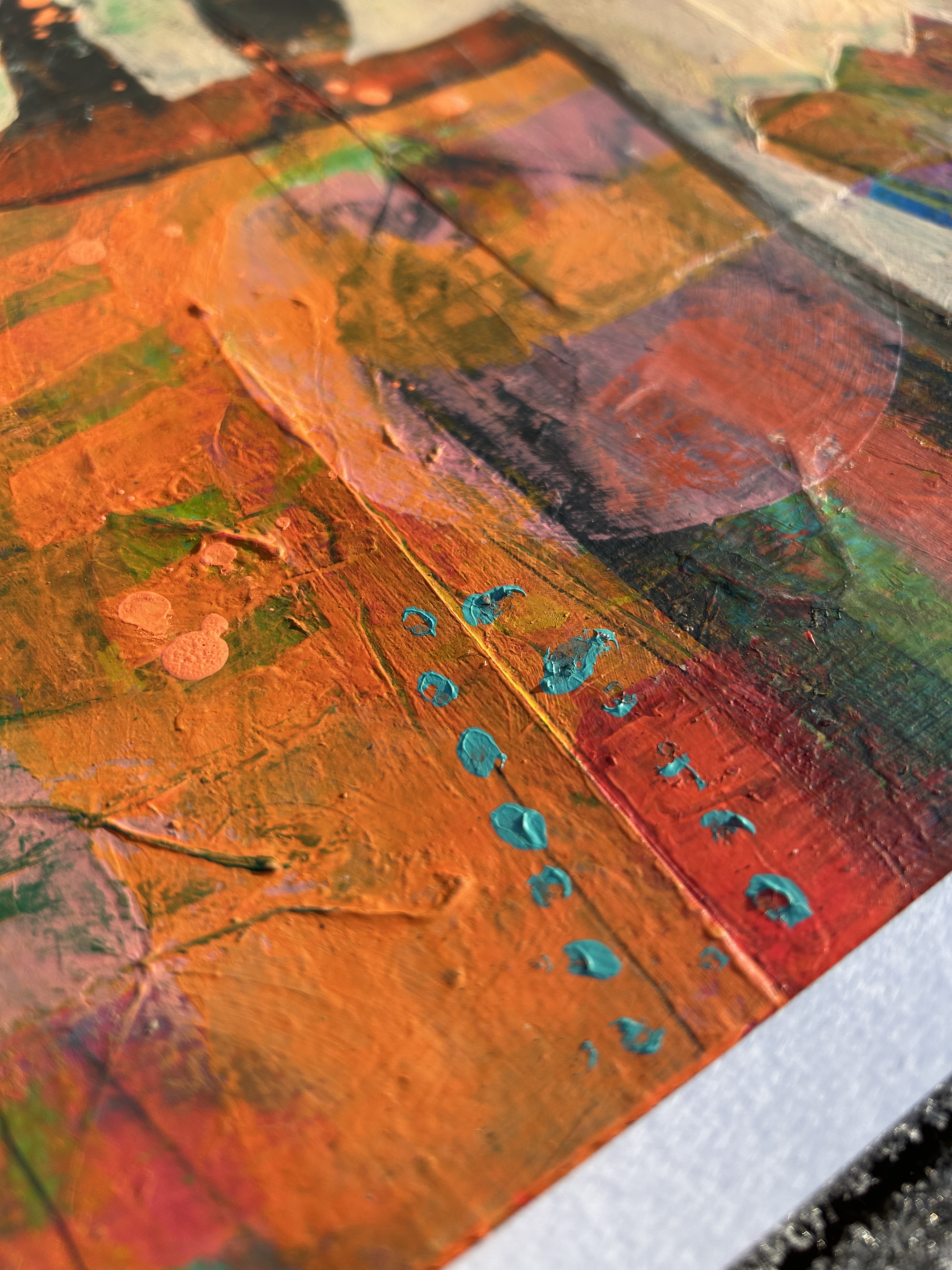 Stacked books on a bookshelf, with book spines in shades of cream, tan, and grey-bronze.