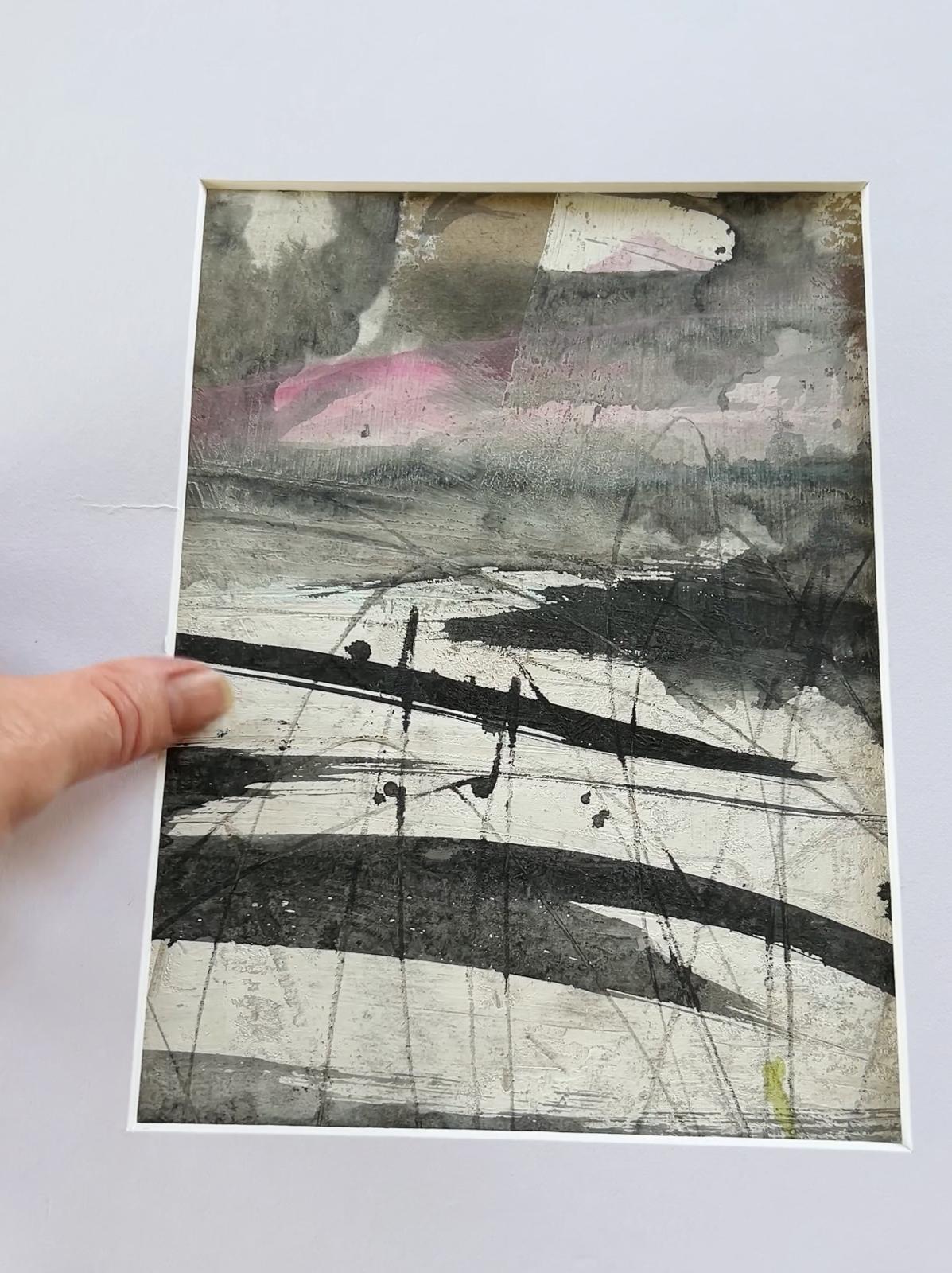 Stacked books on a bookshelf, with book spines in shades of cream, tan, and grey-bronze.